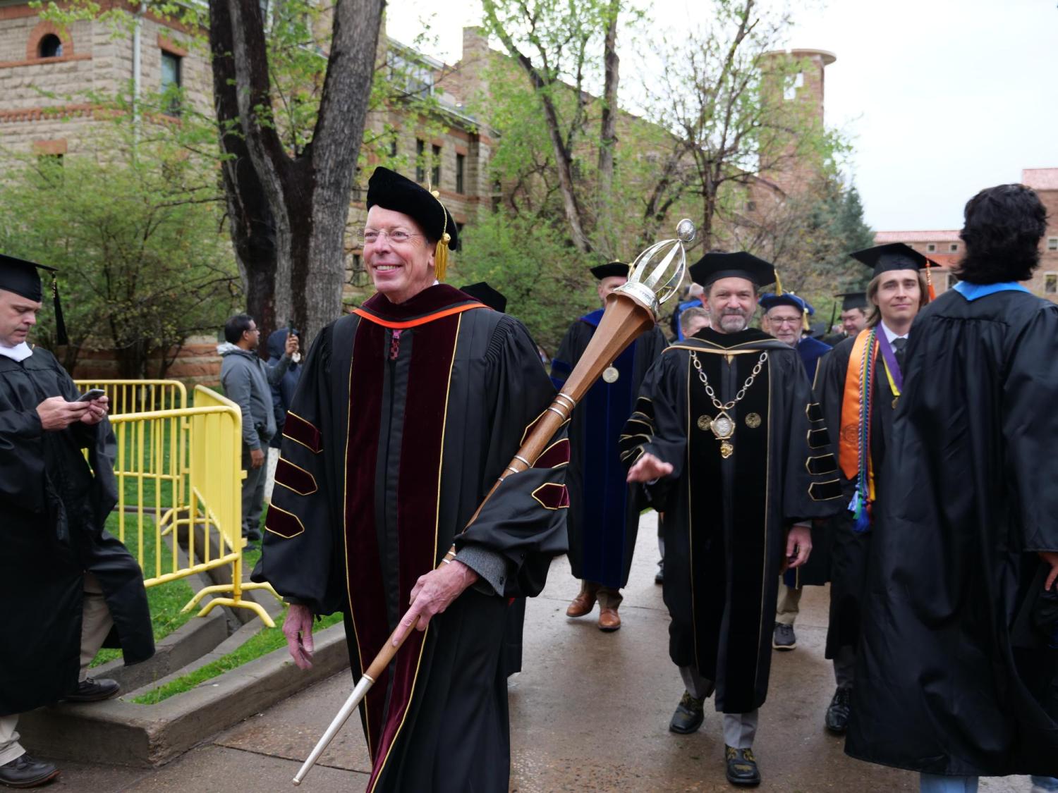 Marshal Bud Coleman holding the mace and leading the procession