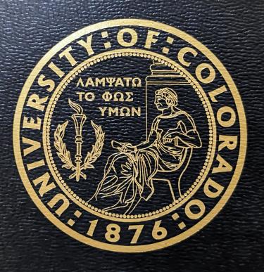CU Boulder seal that reads "let your light shine" in Latin