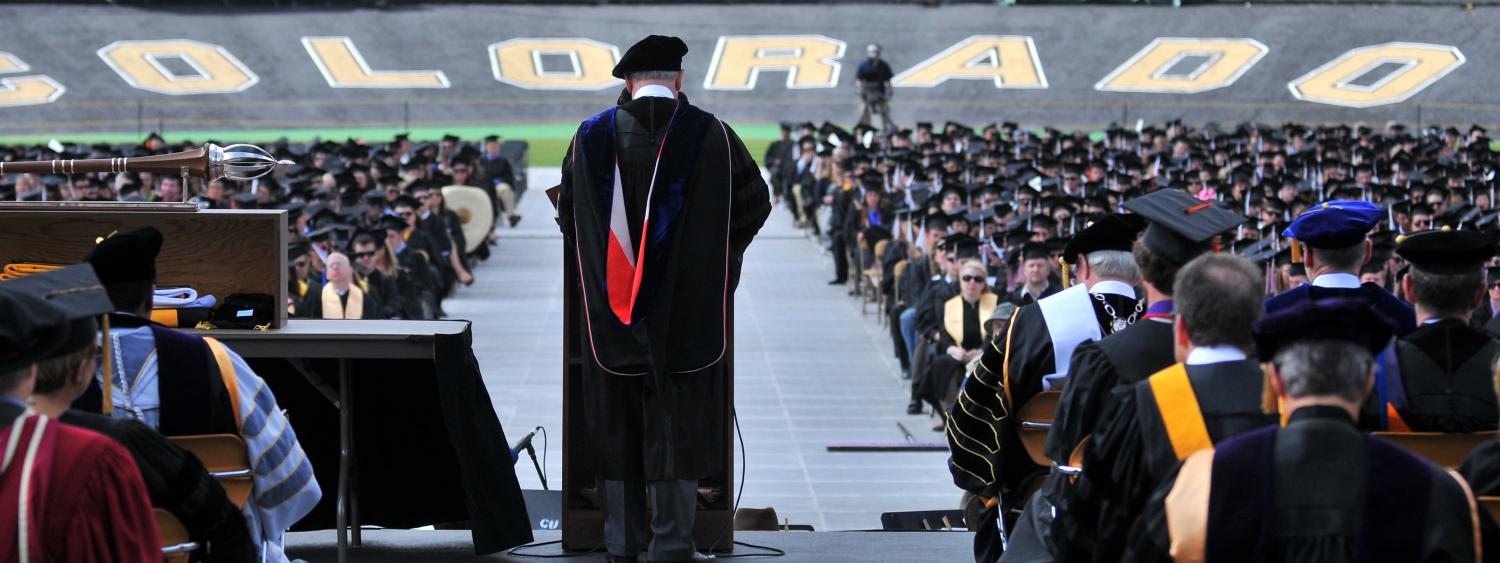 Chancellor Phil DiStefano addressing graduates in Folsom Field