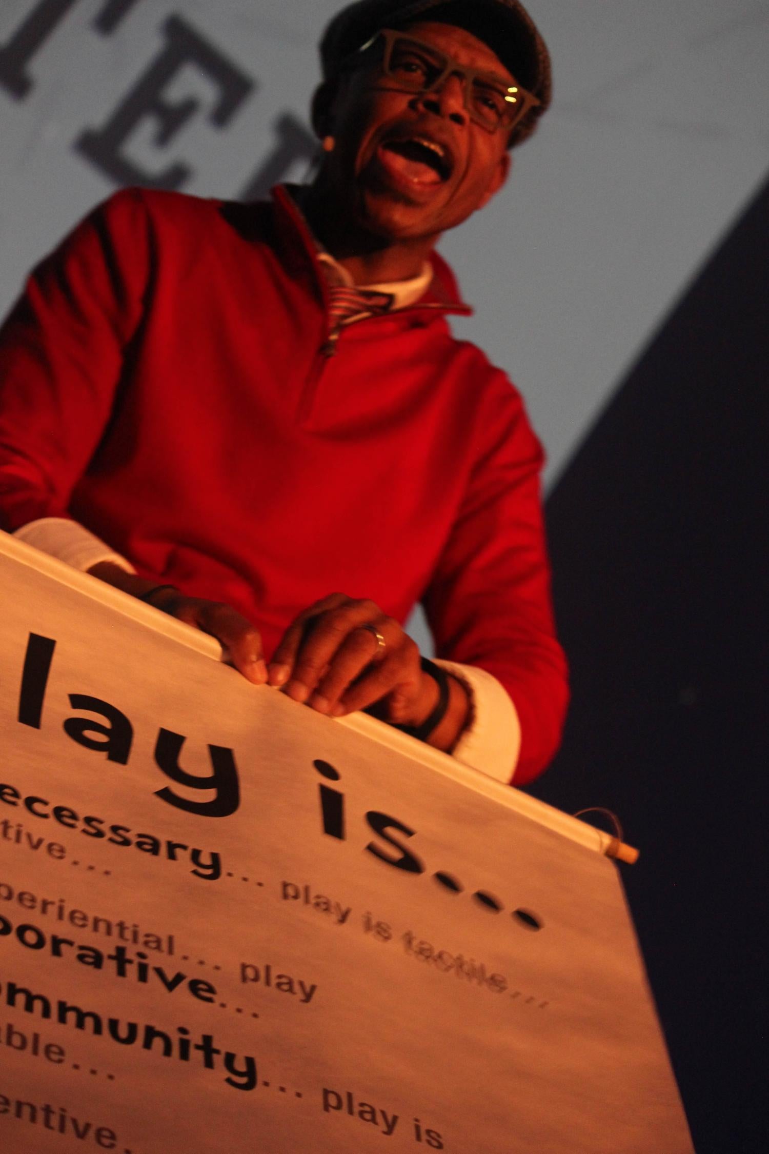 Kevin shows off a scroll about play that he brought for Buckingham's new creative space.