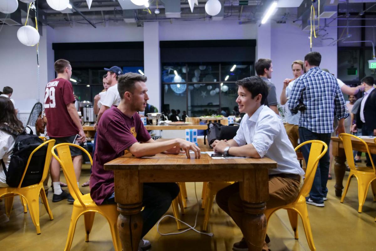 Students conversing at table
