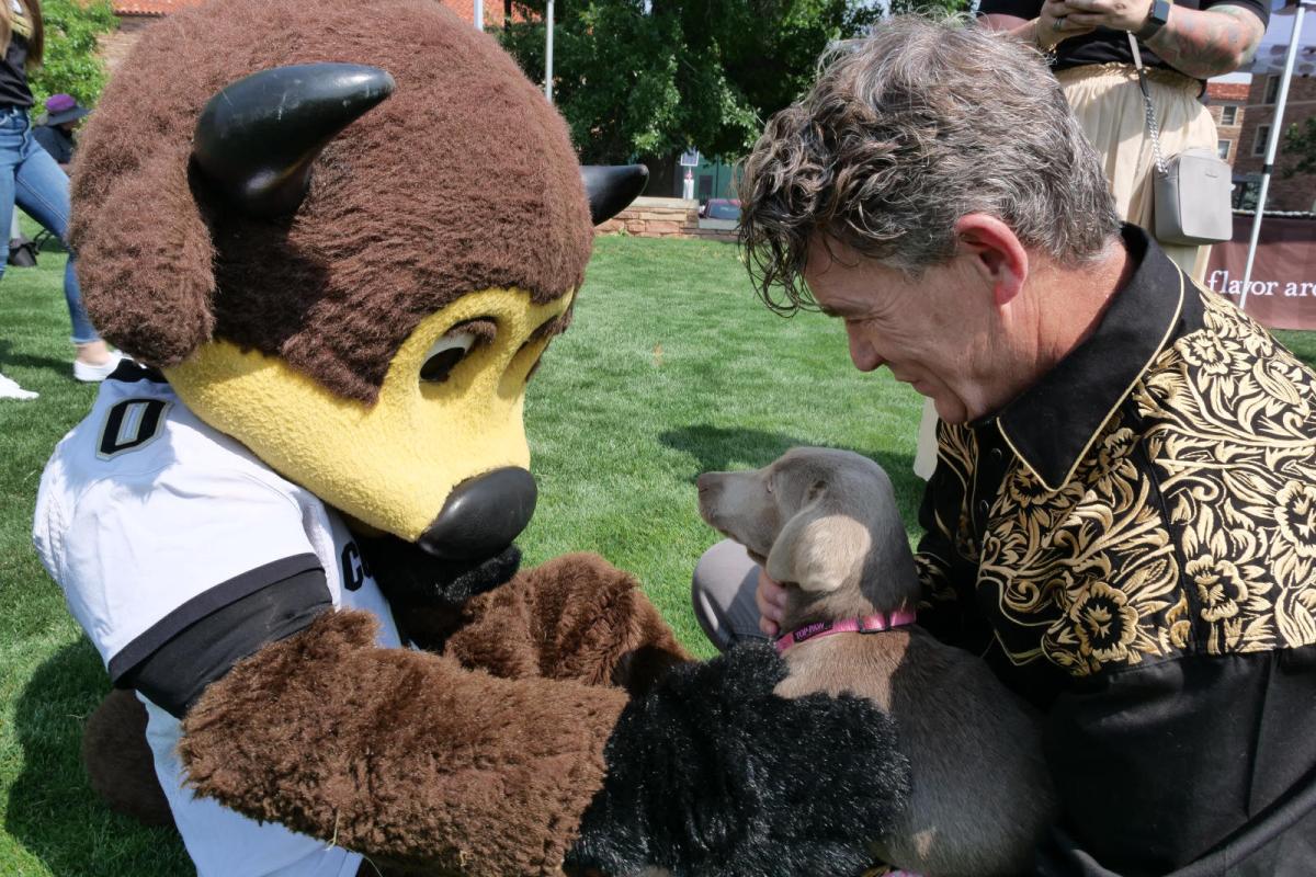 COO Pat O'Rourke with puppy and Chip the Buffalo