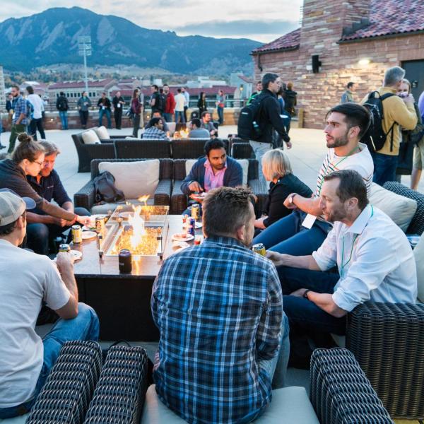 Attendees sitting around a fire pit, talking