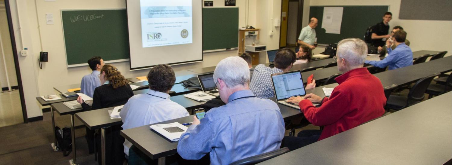 Conference attendees reviewing info on screen