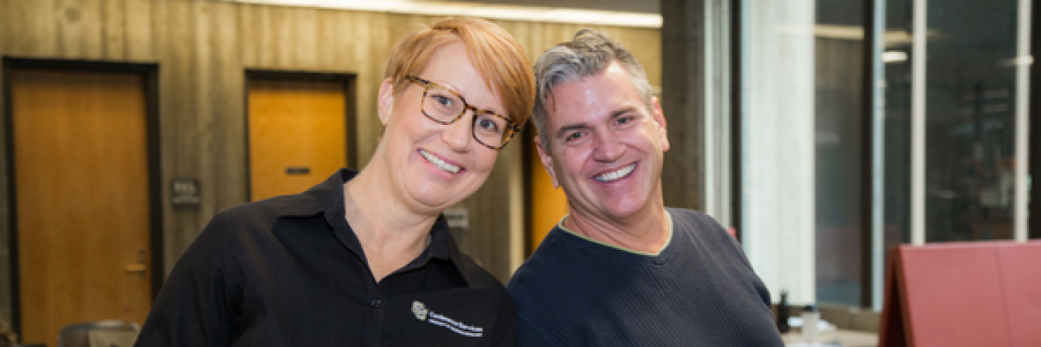 Two CUCS staff members smiling at the camera