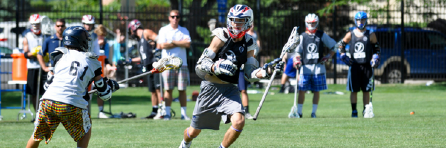 Two camp attendees playing lacrosse