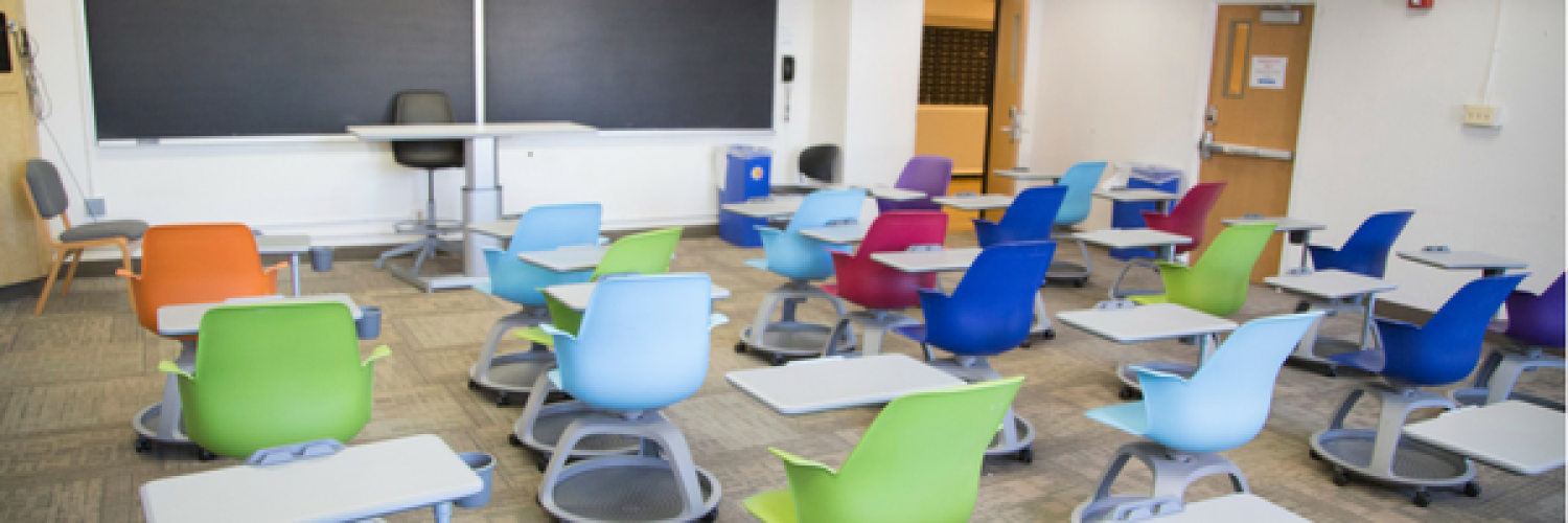 Residence hall classroom with colorful chairs with desks attached