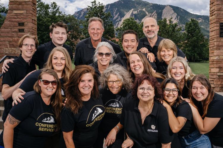 Conference Services Team photo with mountains in the background