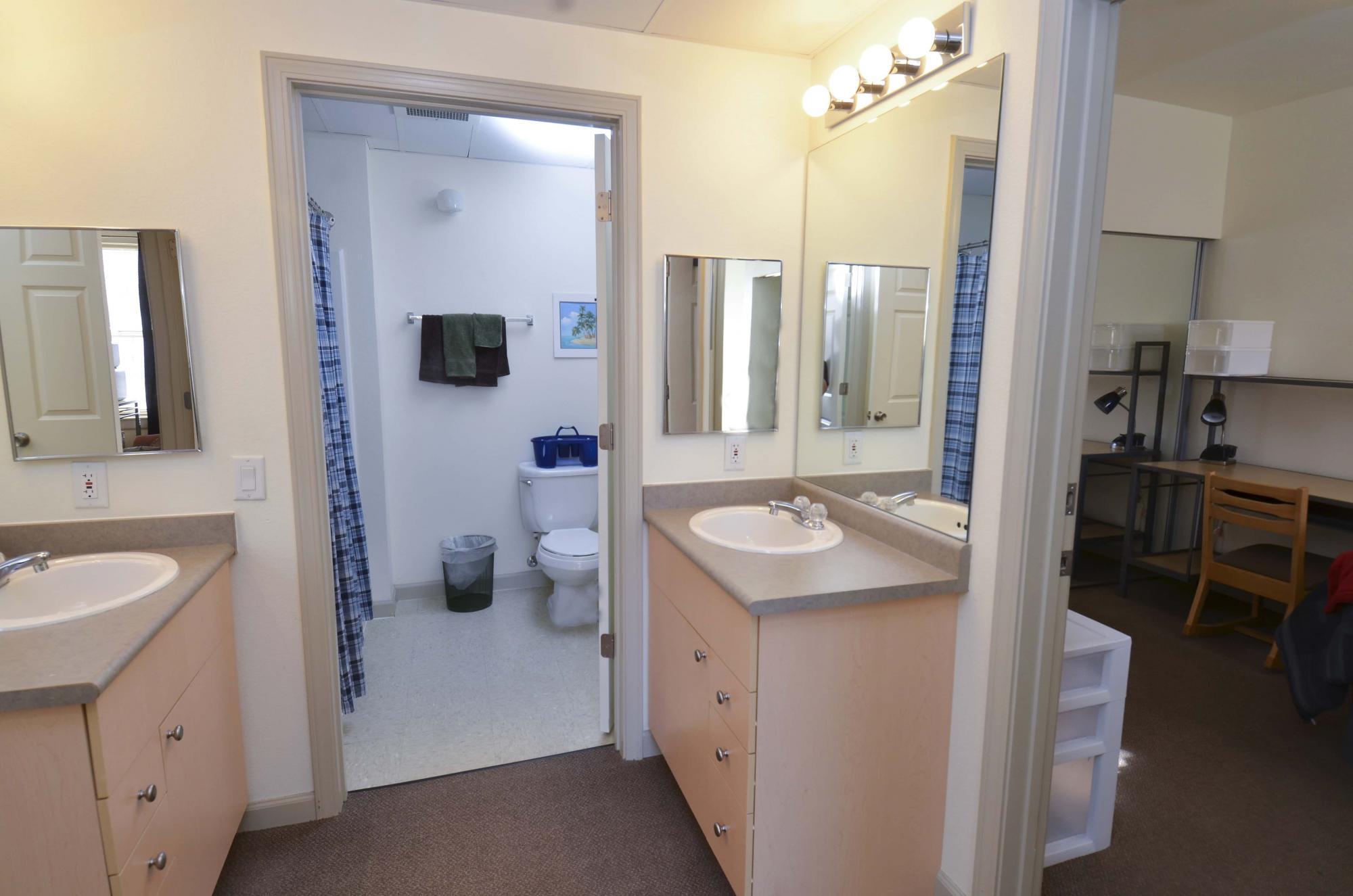 Bathroom area with two vanities and one shower area