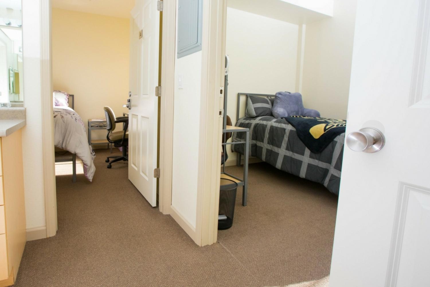 Two Bear Creek single rooms, side by side with a bathroom outside their doors