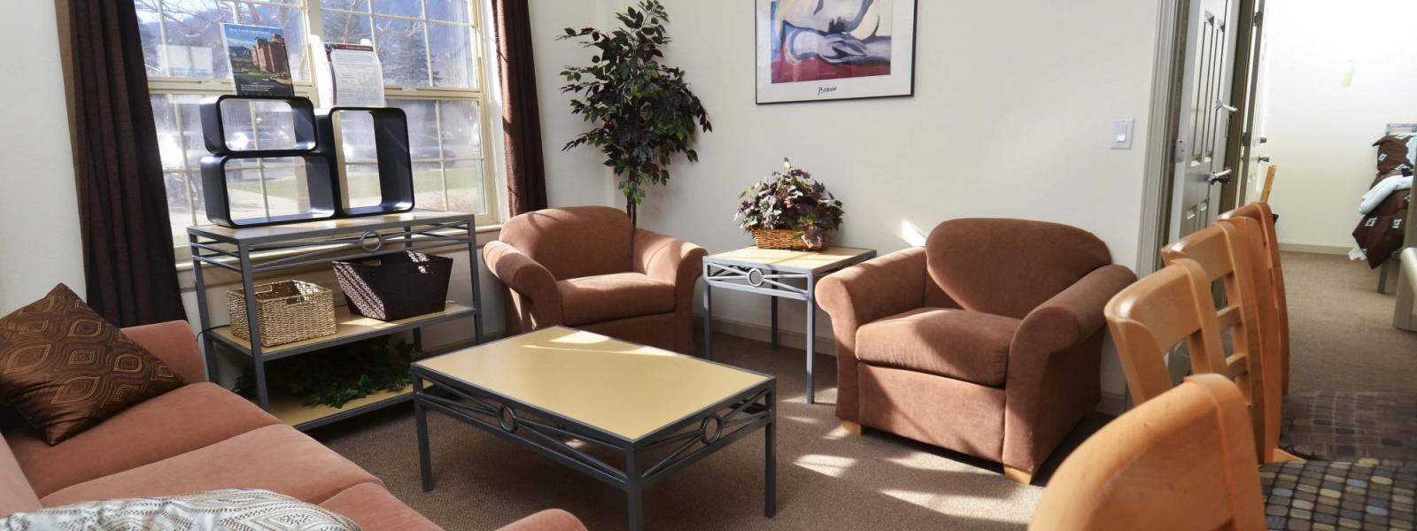 Bear Creek Apartments living room with window, sofa, chairs, coffee and side tables