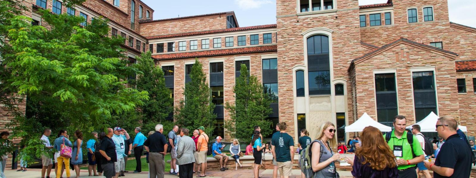 Group of people standing in campus courtyard