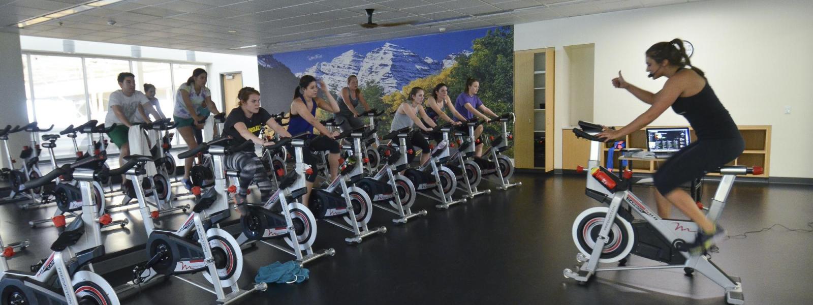 A group of people on stationary bikes