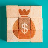 Blocks that are built to show a bag of money with dollar sign