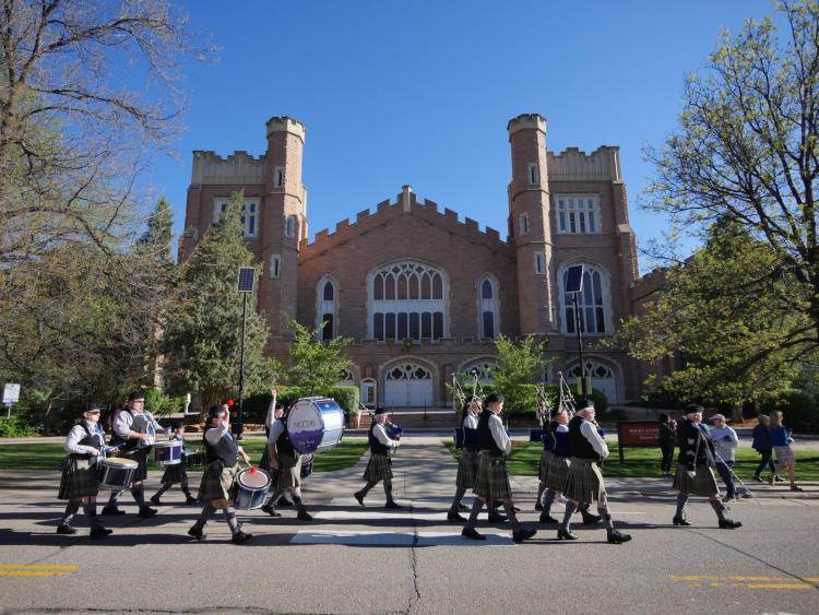 A band marching outside of Old Main