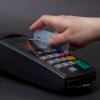 Hand swiping a credit card on a machine