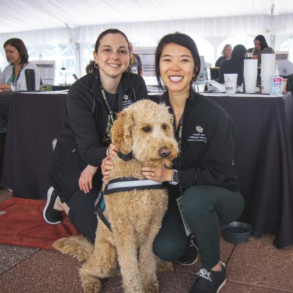 Two people with a therapy dog