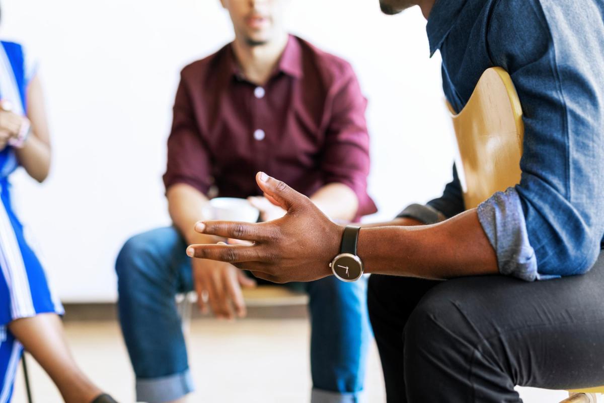 Photo of students engaging in a process group therapy session for students of color.