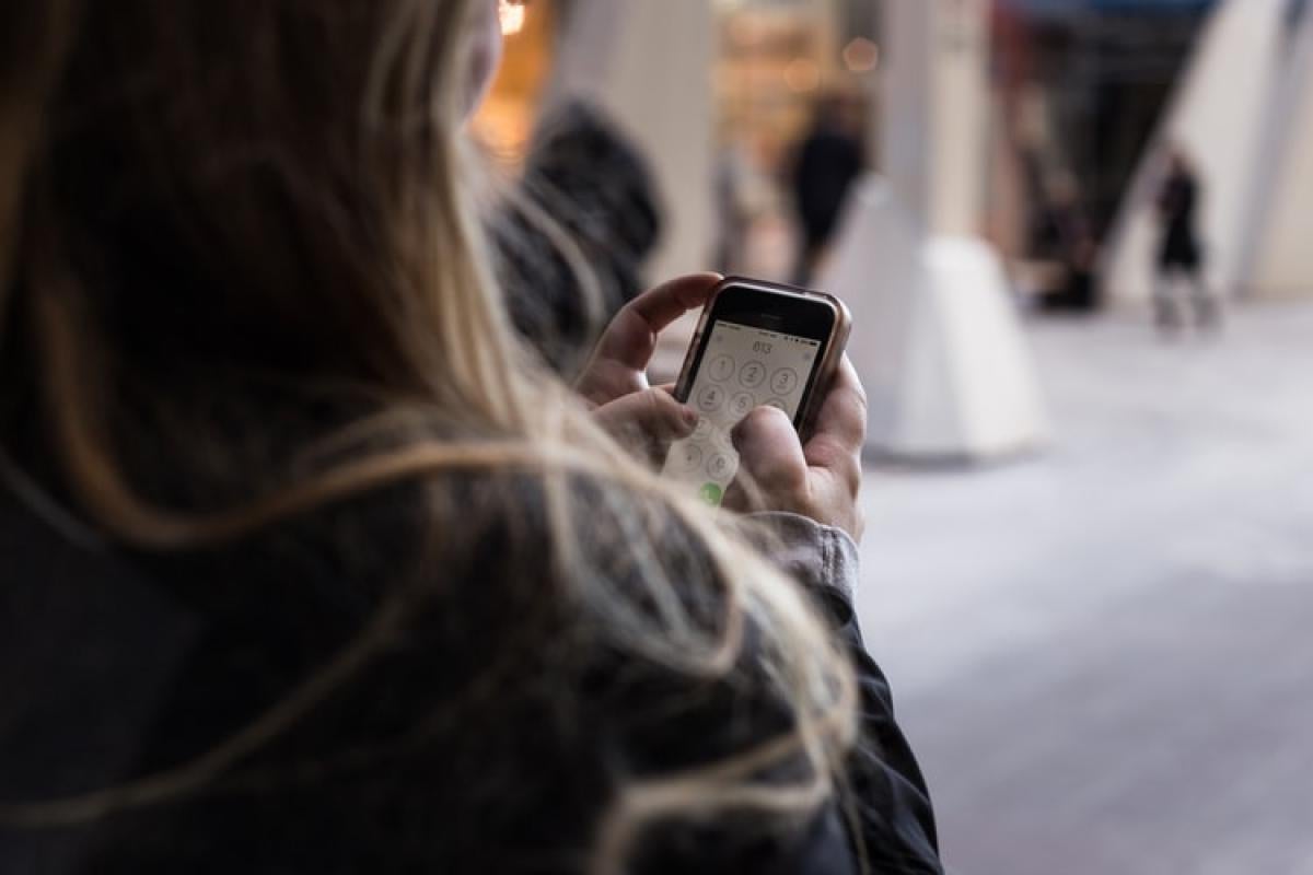 Person dialing cell phone number