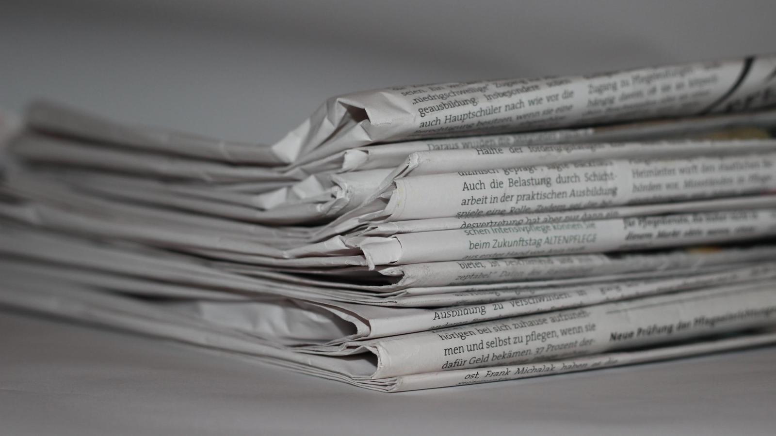 stack of print newspapers