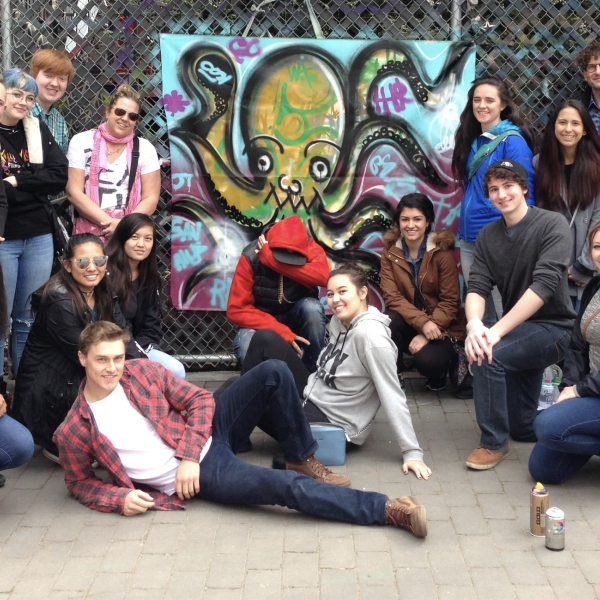 Photo of students by student painted mural