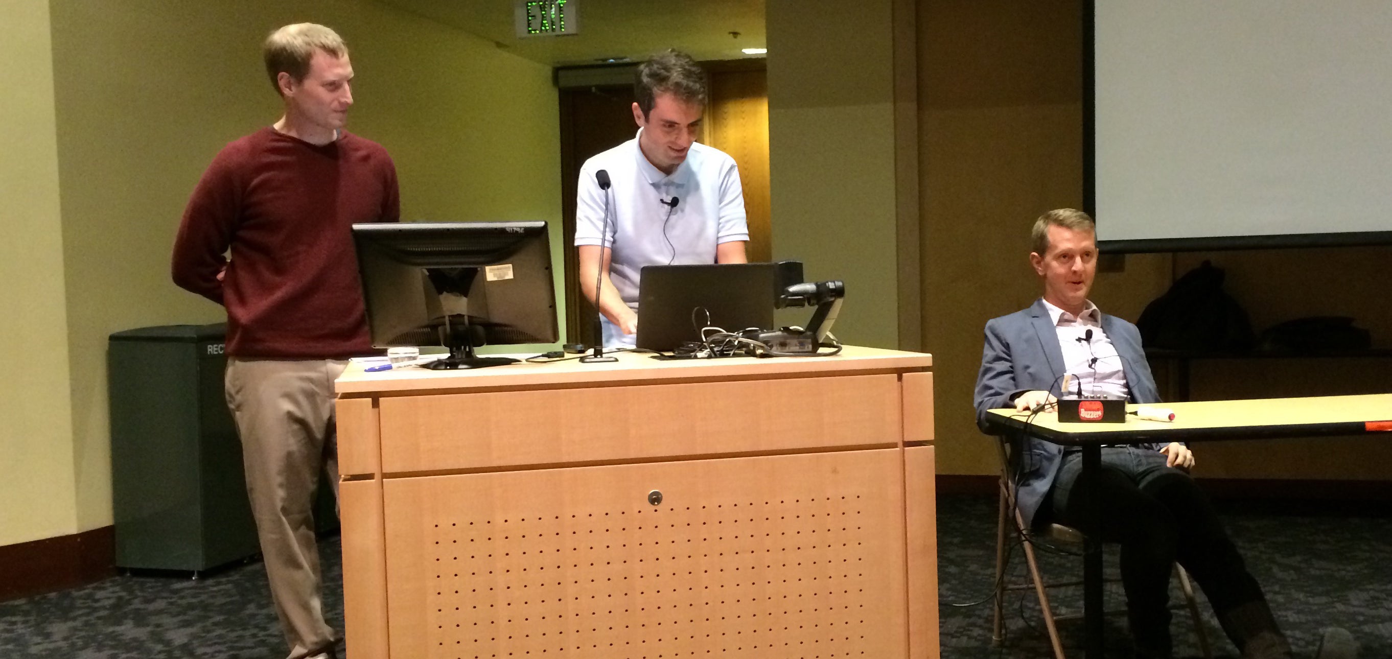 Jordan Boyd-Graber and a student man the QANTA computer while Ken Jennings awaits a question. 