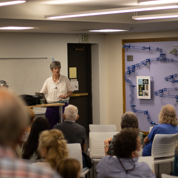 People listen to remarks by Elizabeth Bradley