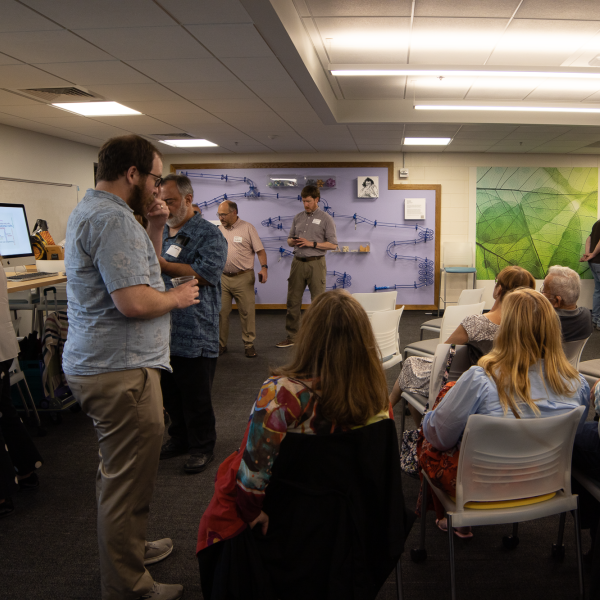 People listen to remarks during the celebration of Mike Eisenberg