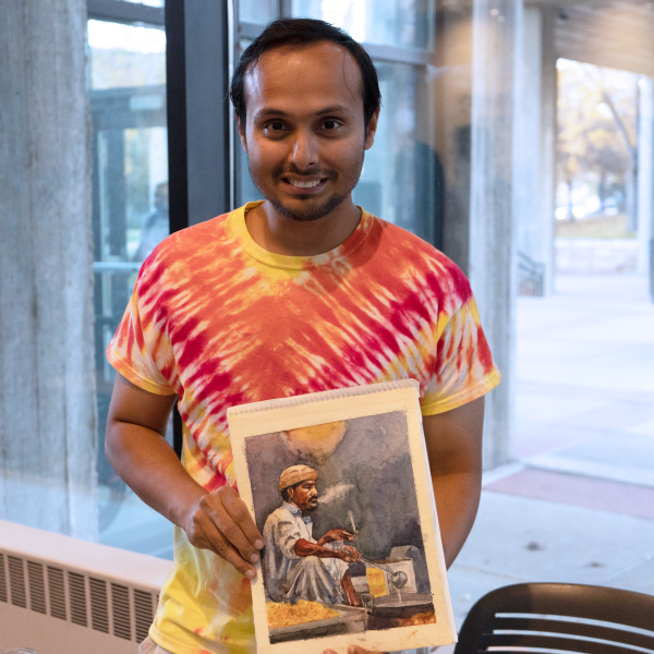Student shows painting at the CS Cross cultural celebration