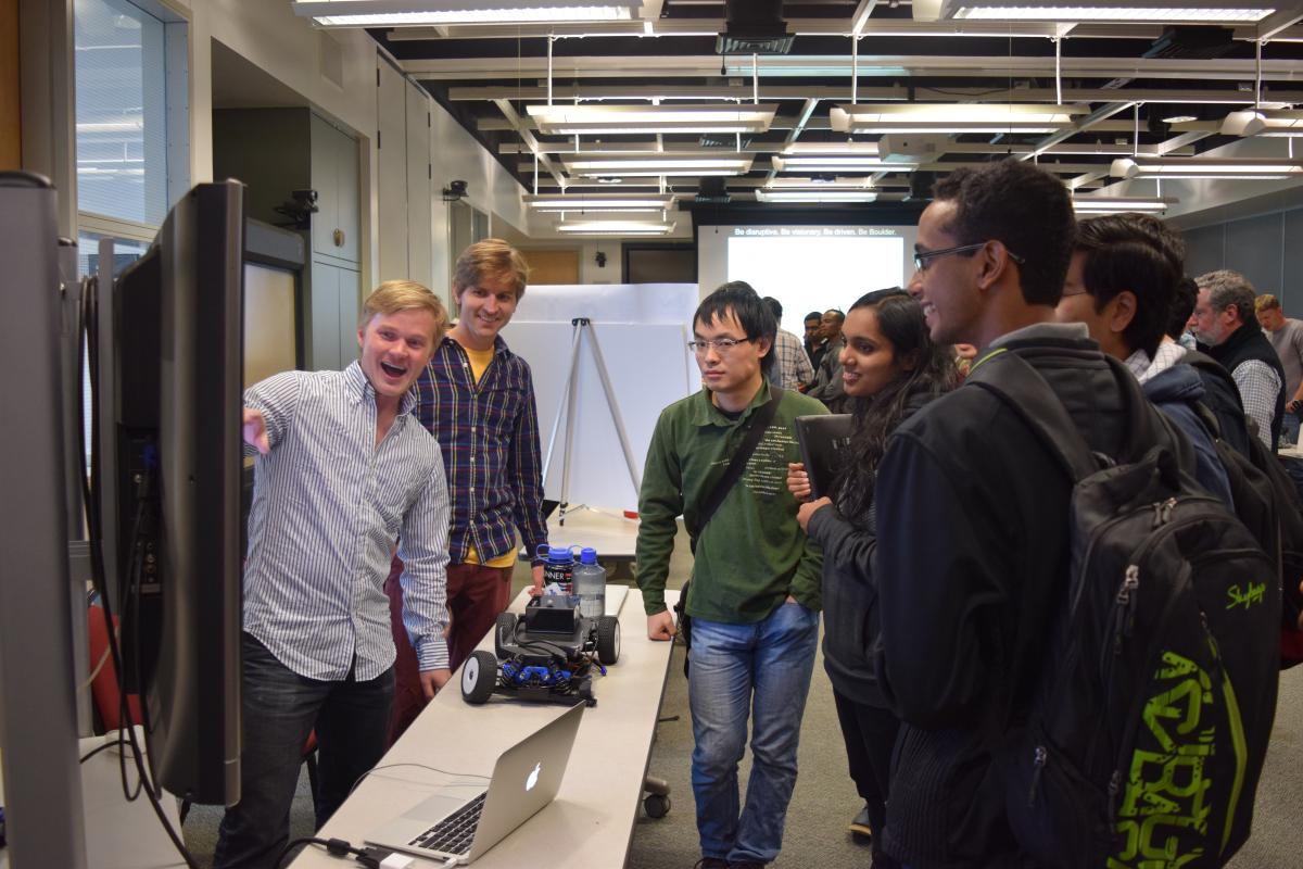 Assistant Professor Chris Heckman shows off his team's research to prospective graduate students. 