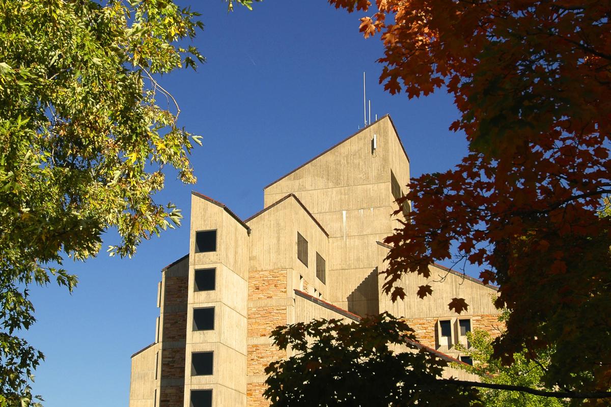 The Engineering Center tower with fall leaves in the foreground.