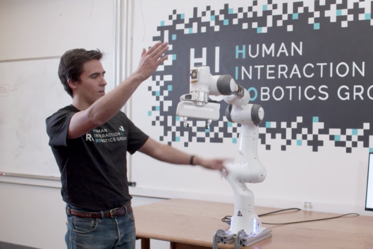 Person interacts with robotic arm