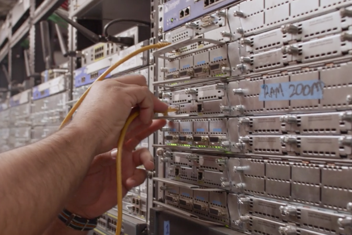 A person plugs a cord into a network array