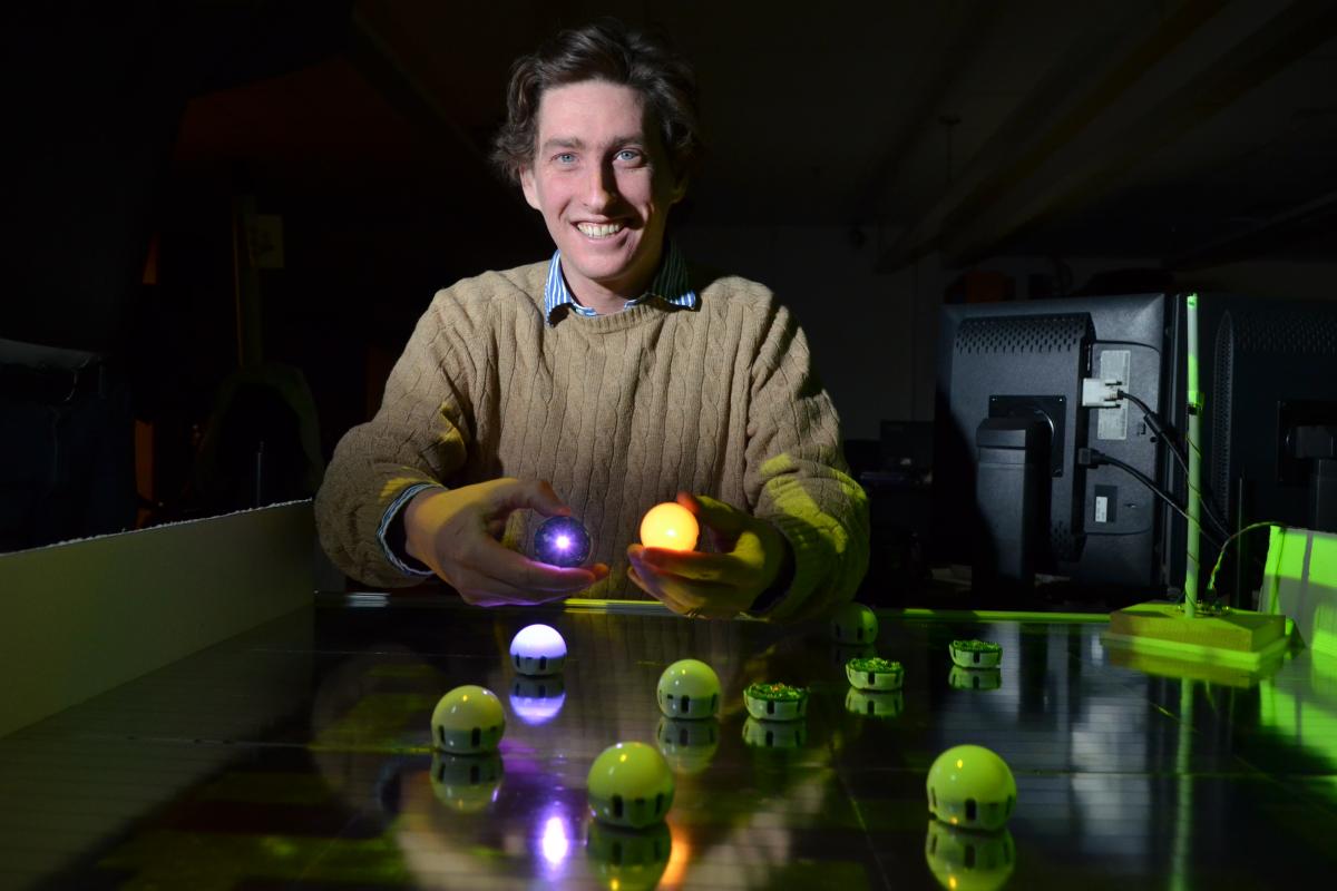 Assistant Professor Nikolaus Correll demonstrates his team's swarm robots. 
