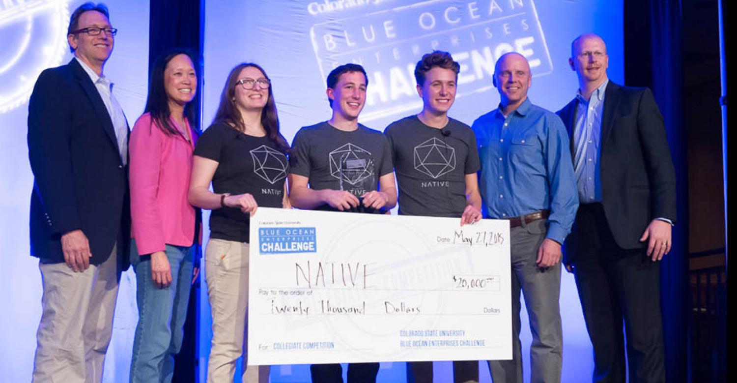 The three Native founders pose with a giant novelty check at the Blue Ocean Enterprises award ceremony.