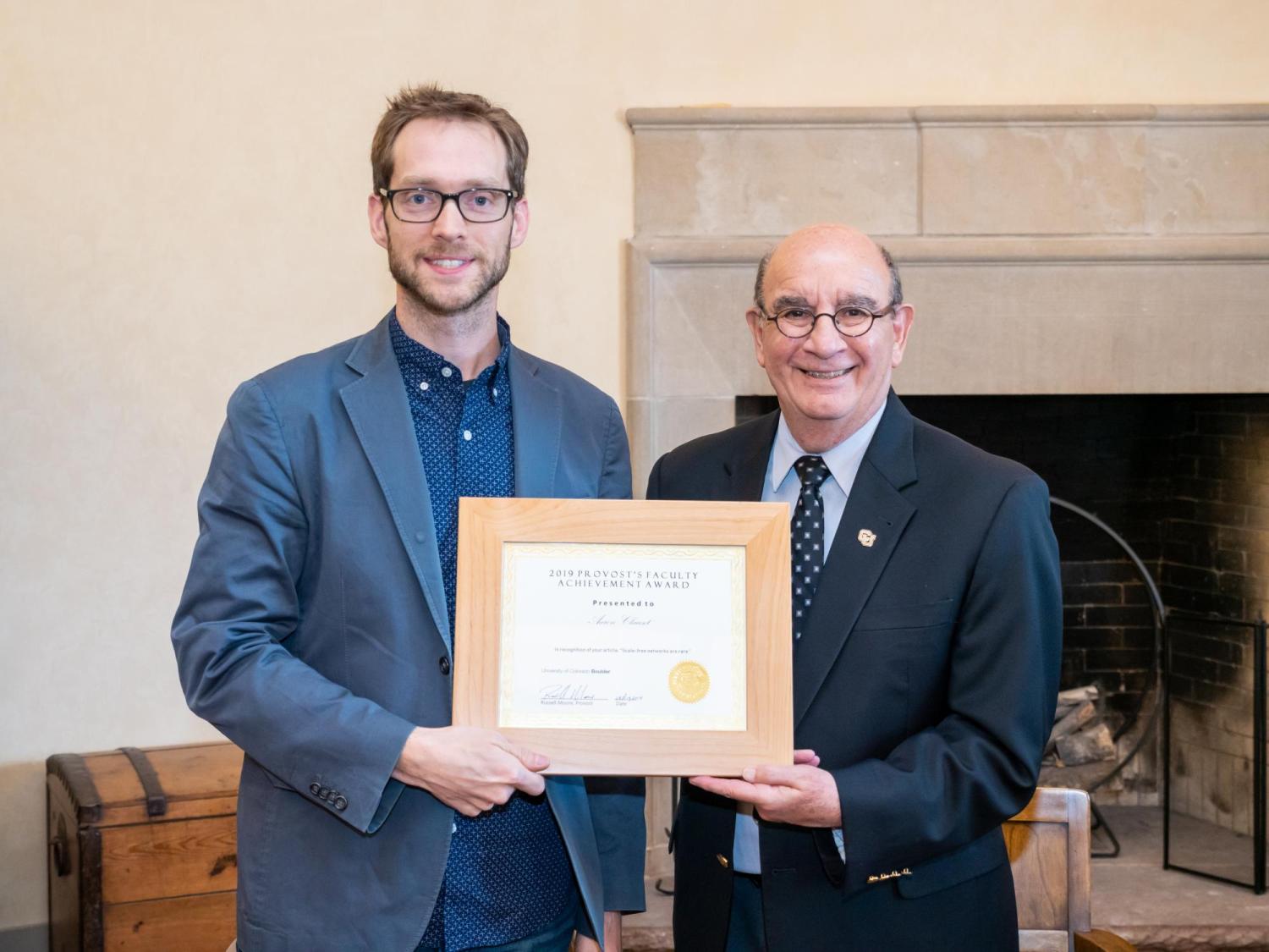 Clauset receives his award from CU Boulder Chancellor Phil DiStefano