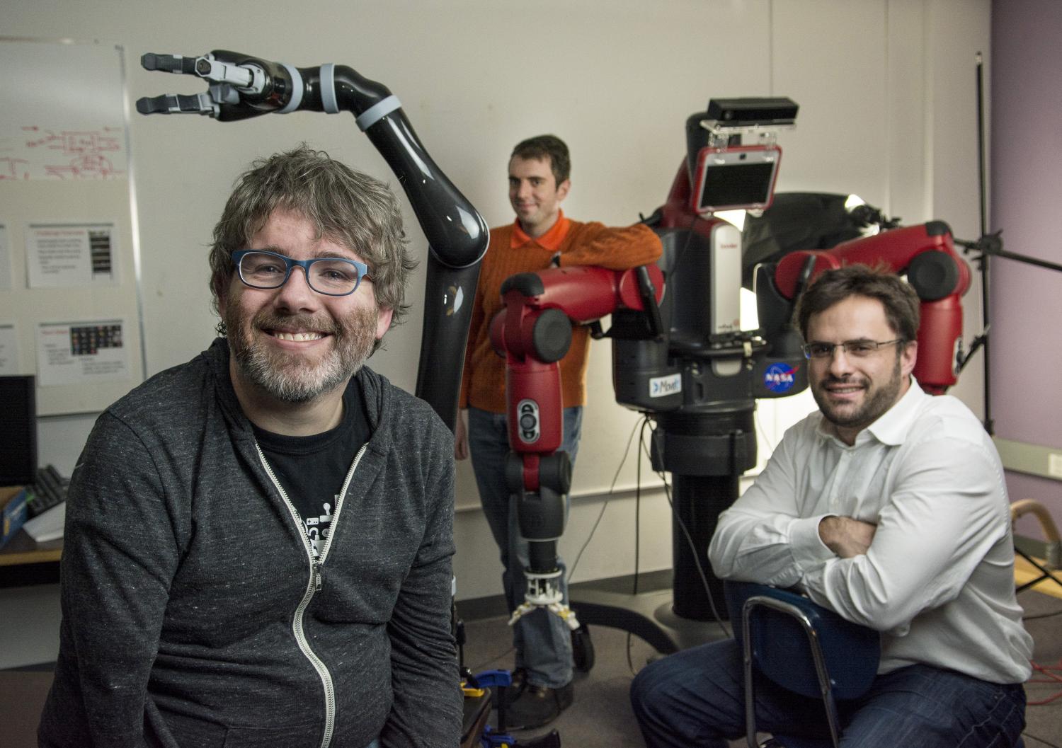 Shaun Kane, Jordan Boyd-Graber and Gabe Sibley pose for a group photo in a CS robotics lab