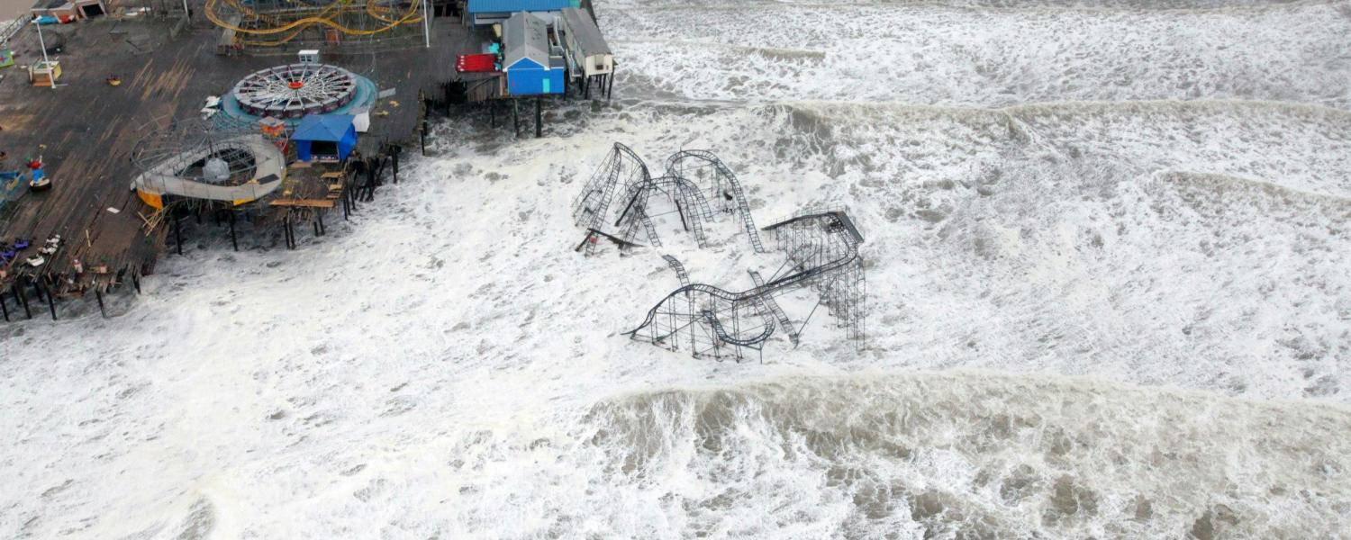An aerial photo of Hurricane Sandy washing away a pier in New Jersey