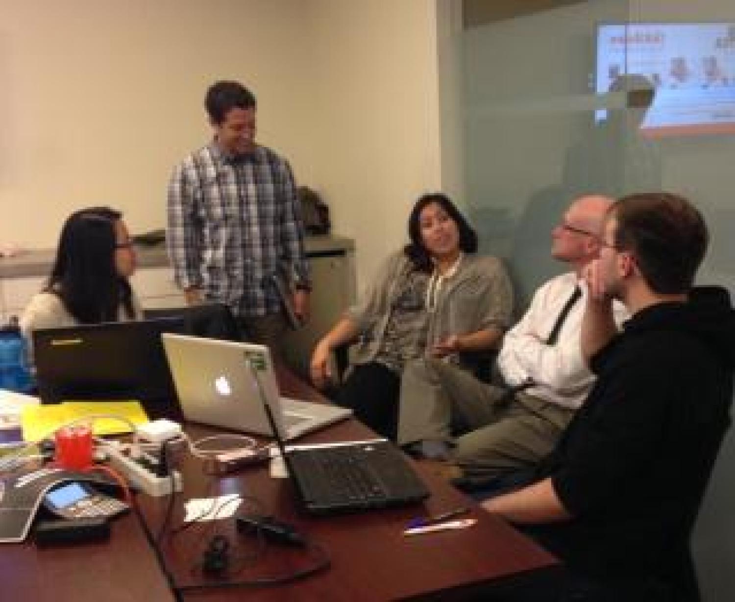Students discuss a big data project with Zayo staff members.
