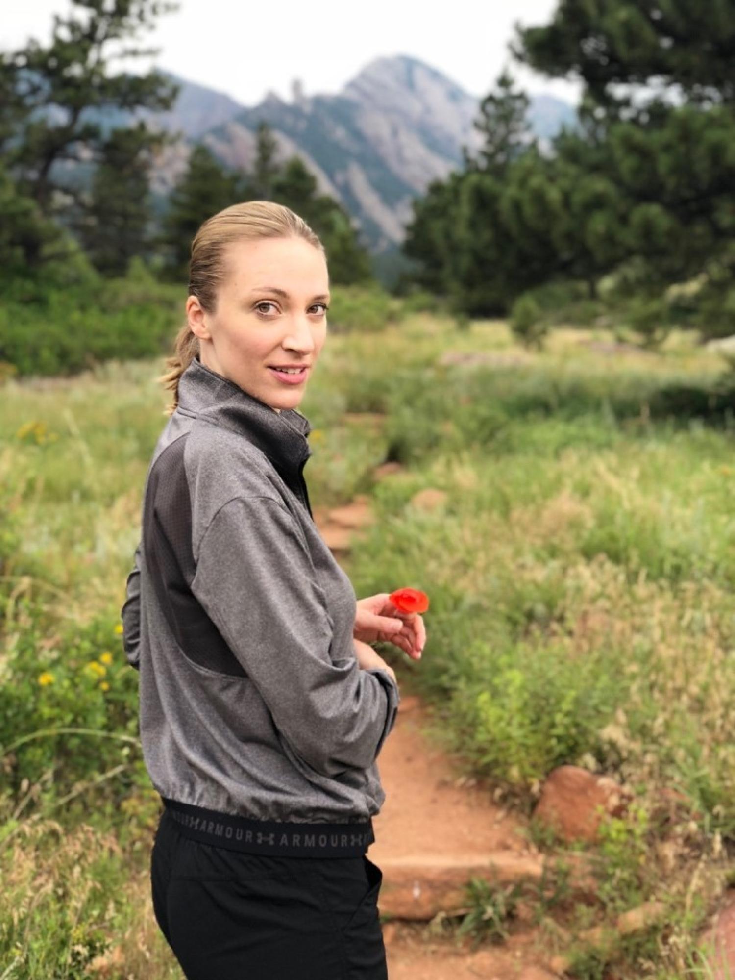 Layne hiking with the Flatirons in the background.