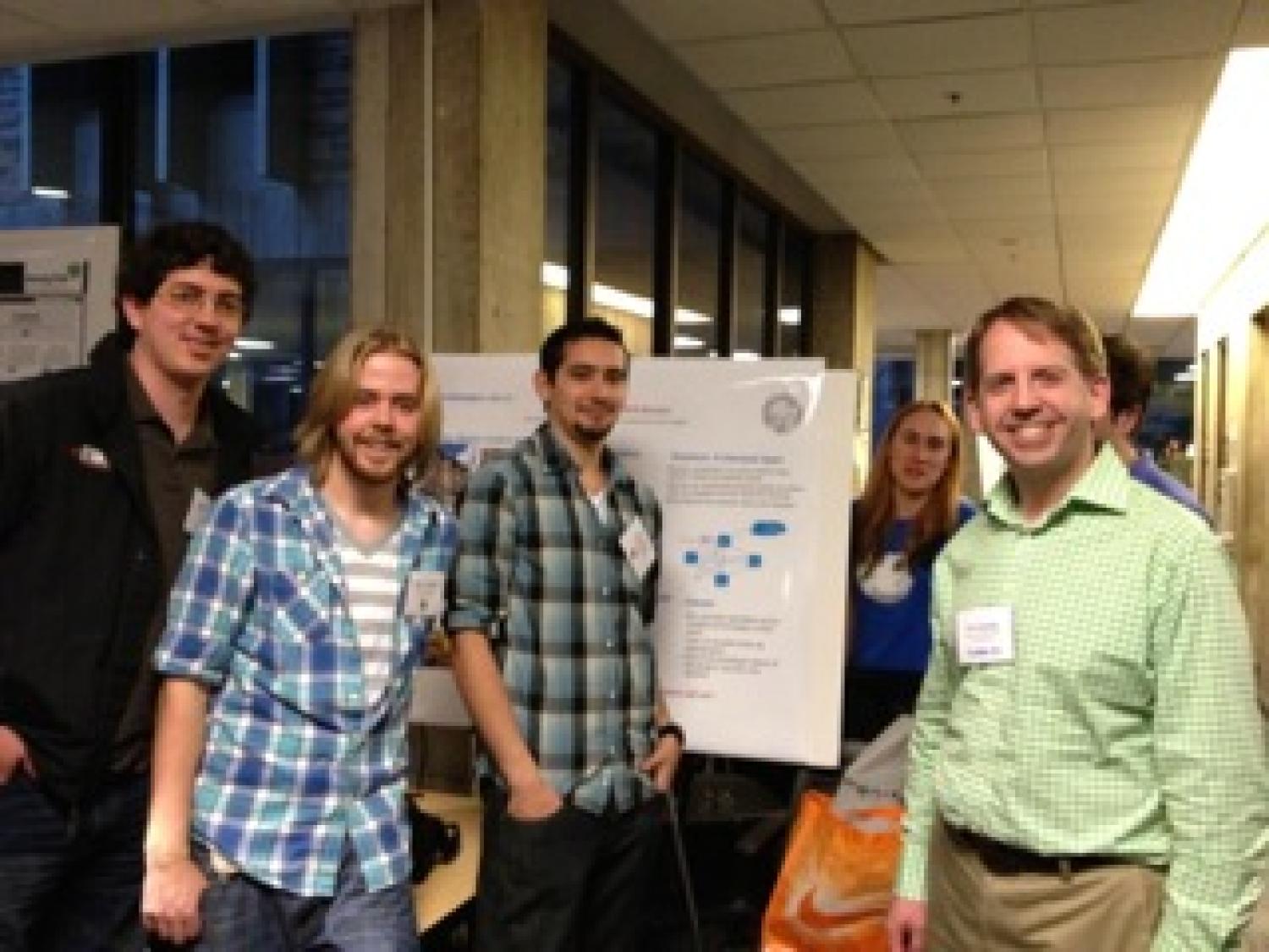 The with their poster at the senior project expo.