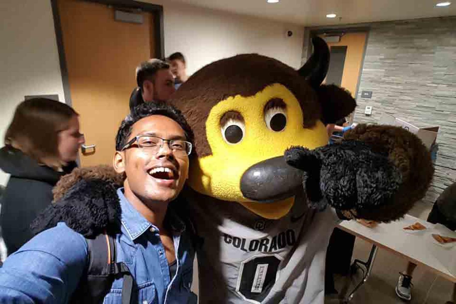 A selfie of Gupta with Chip the buffalo mascot.