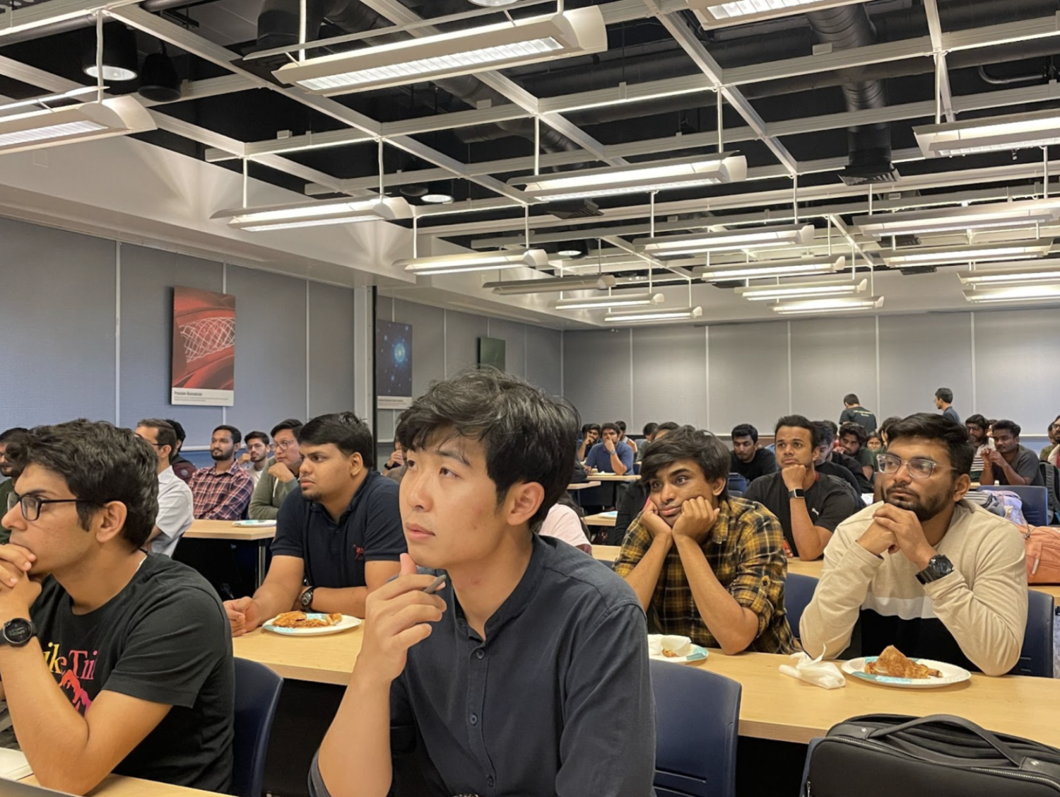 People at a graduate development club session listening to a recruiter