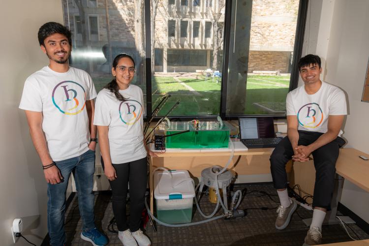 Sudarshan Sridhar, Pooja Natarajan and Ibrahim with the automated algae growth system in yogh group t-shirts