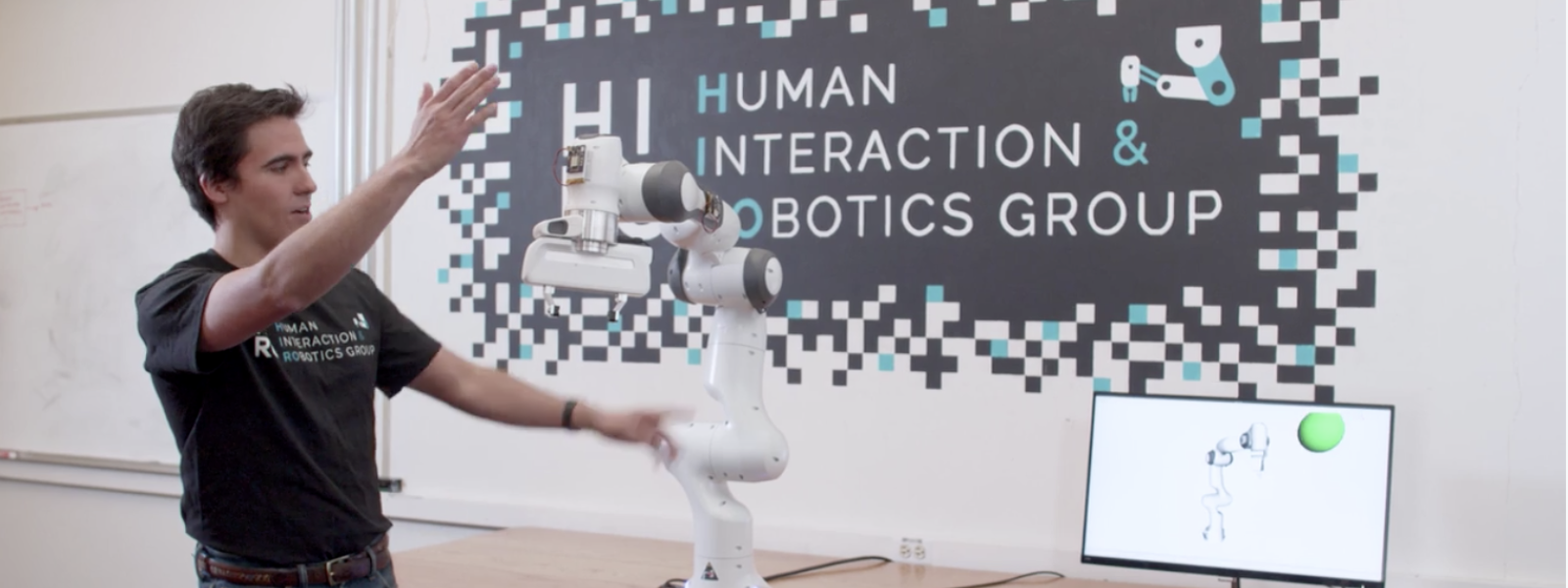 Human interacting with a robot arm