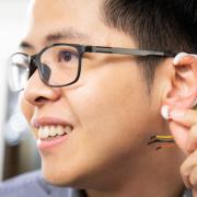 Tam Vu modeling a prototype of an 'earable' device