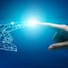 A human hand reaching out to touch a virtual hand