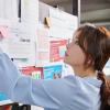 Woman looks at research board