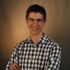 Ryan Slocum, a person with short dark hair and a checkered shirt