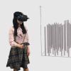 A person wearing a VR headset stands next to computer generated graph